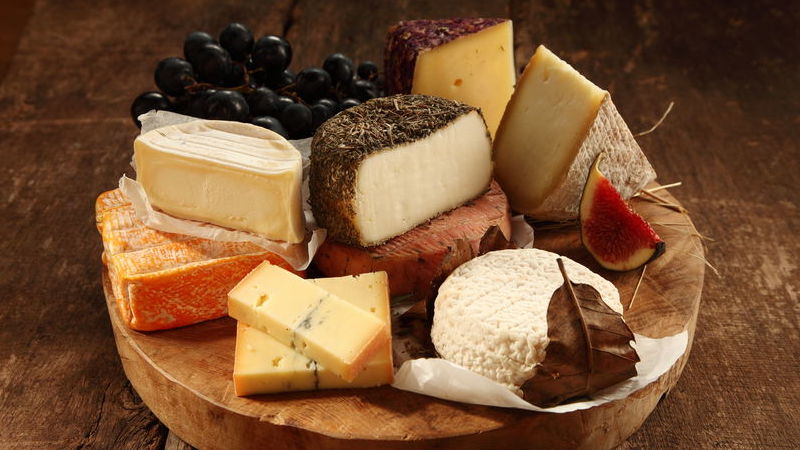 Assorted cheeses on a rustic platter